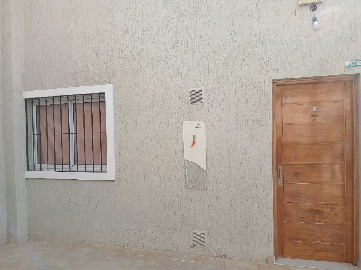 Alquilo departamento planta baja. Estar comedor cocina amoblada, 2 dormitorios con cochera techada.
